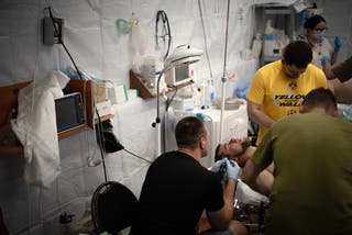 Ukrainian doctors treat a soldier